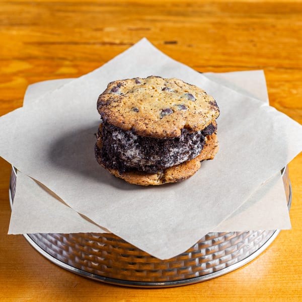 A Skirted Heifer ice cream sandwich with chocolate chip cookies and cookies and cream filling.
