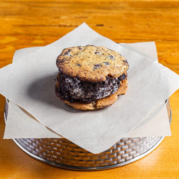 A Skirted Heifer ice cream sandwich with chocolate chip cookies and cookies and cream filling.